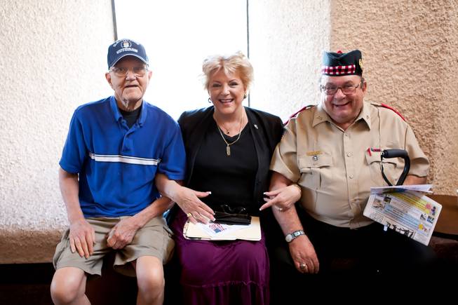 Las Vegas Mayor Carolyn Goodman poses for a photo with two of her favorite veterans, Air Force Sgt. Don Wallace, left, and Navy Petty Chief Officer Alec "Bud" Geren, while attending the 48th Annual Memorial Day Service at the Palm Downtown Mortuary and Cemetery in Las Vegas, Monday, May 27, 2013.